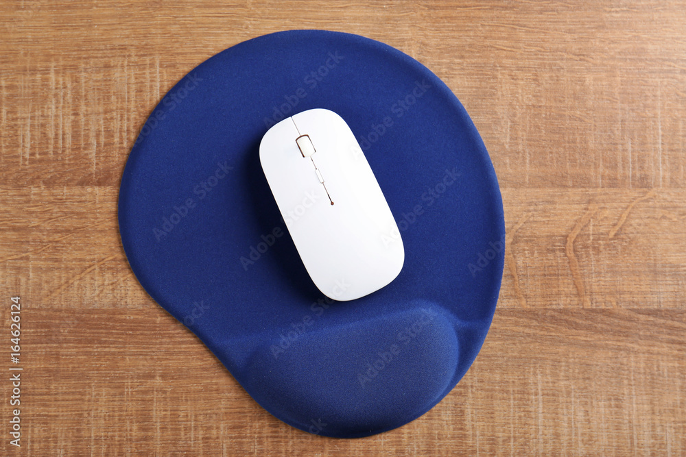 Blank mat and wireless mouse on wooden background Blank mat and wireless mouse on wooden background