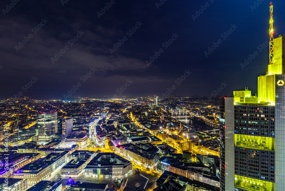 Fototapeta premium Skyline of Frankfurt, the financial capital of Germany, at night with crescent moon. HDR photograph taken from the top of Main Tower.