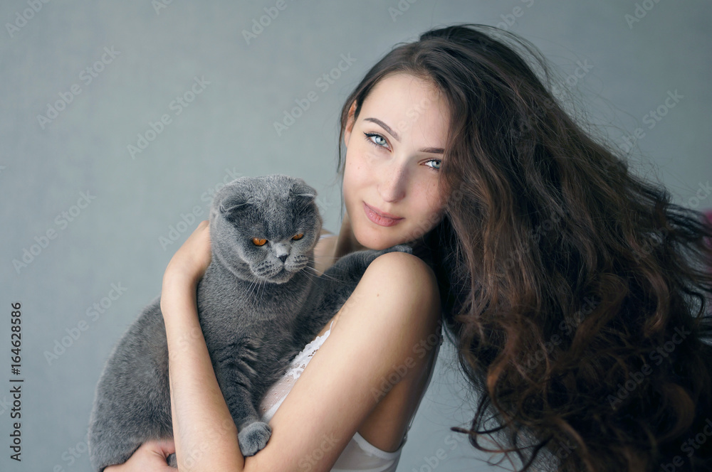 Beautiful brunette girl in underclothes with cat resting at home Beautiful brunette girl in underclothes with cat resting at home