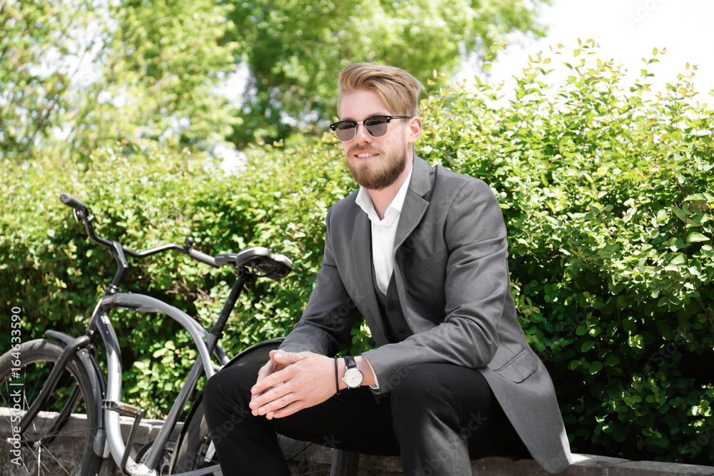 Young man with bicycle in park