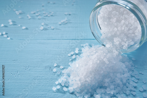 closeup of a small sea salt pile spilled from jar