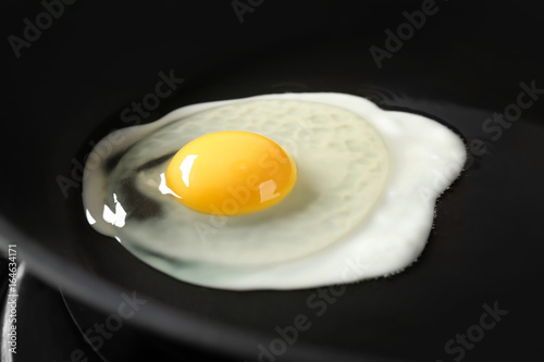 Delicious over easy egg in pan, closeup