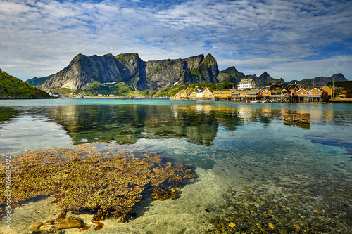 Scenic fjord on Lofoten islands with typical red fishing hut, Sakrisoy, Norway