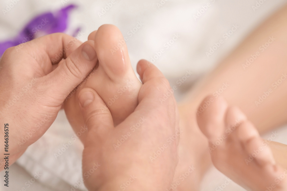 Young woman having foot massage in spa salon, closeup Young woman having foot massage in spa salon, closeup