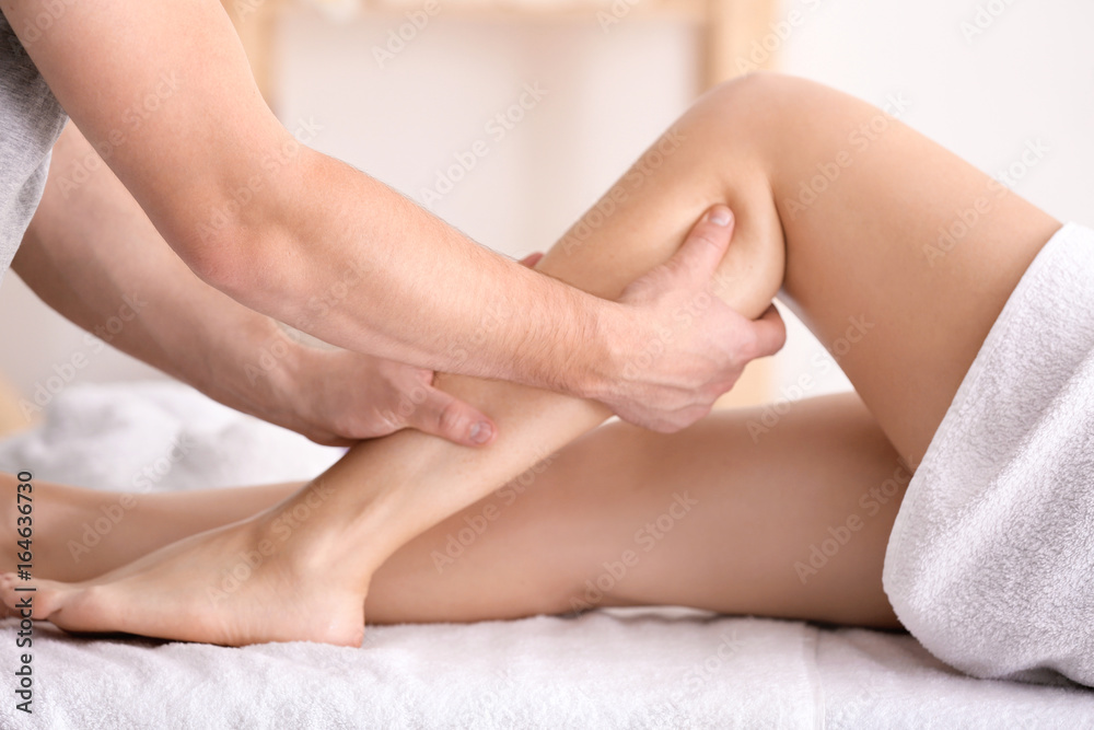 Young woman having legs massage in spa salon Young woman having legs massage in spa salon