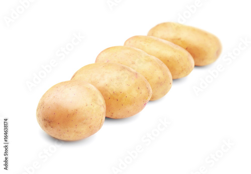 Raw unpeeled potatoes on white background