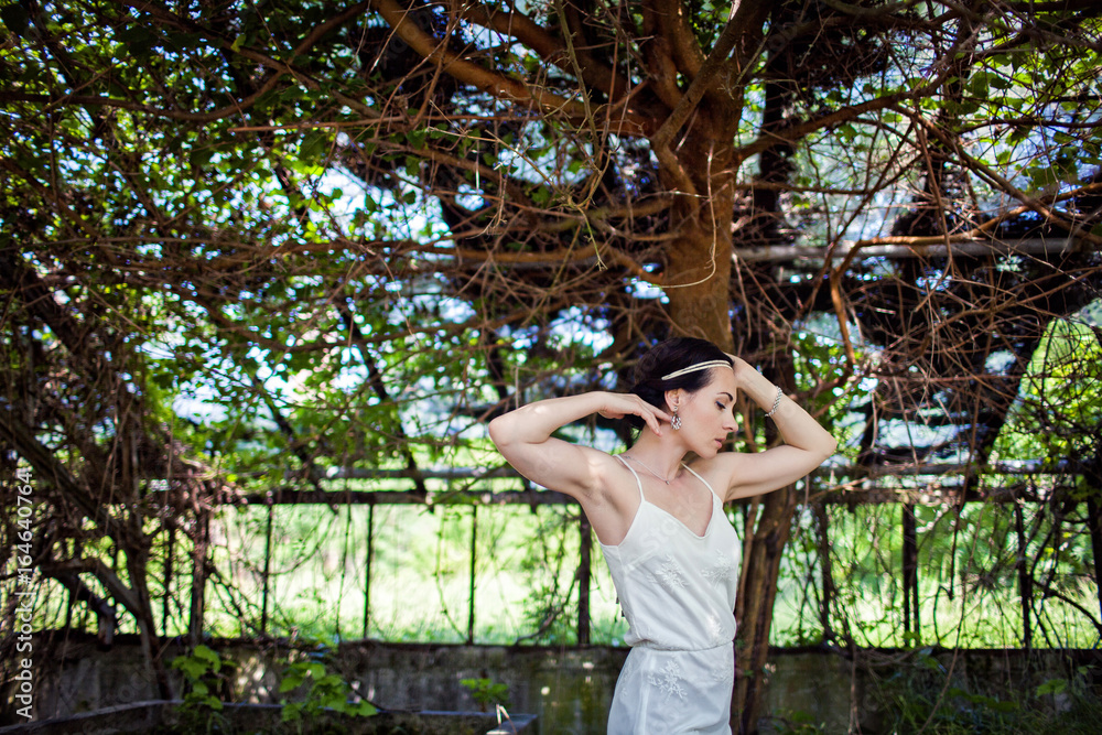 girl in short white Board is in an abandoned greenhouse