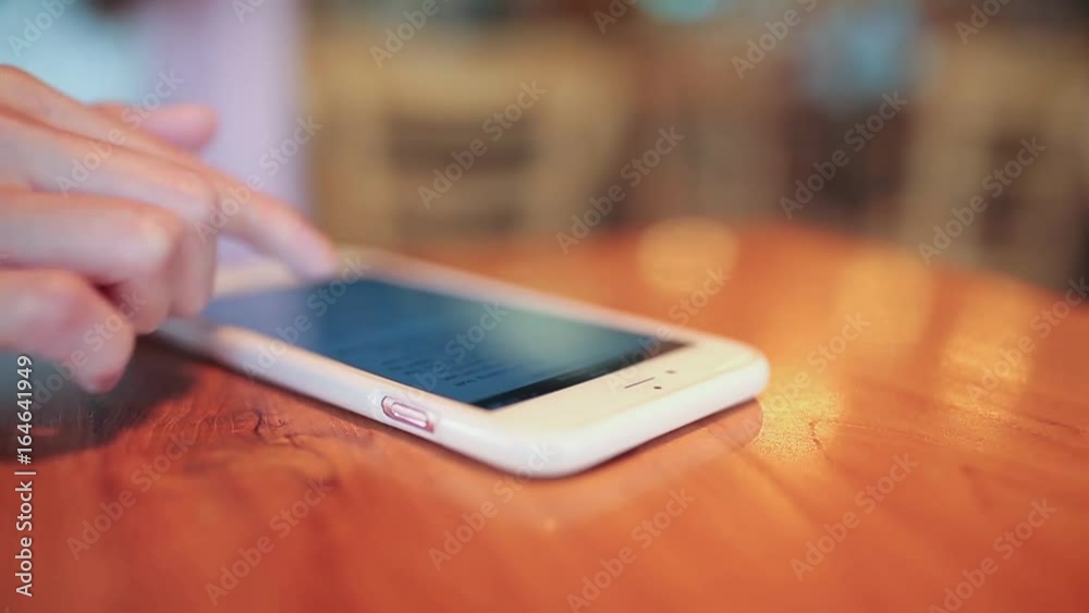 Woman use of mobile phone inside cafe Woman use of mobile phone inside cafe