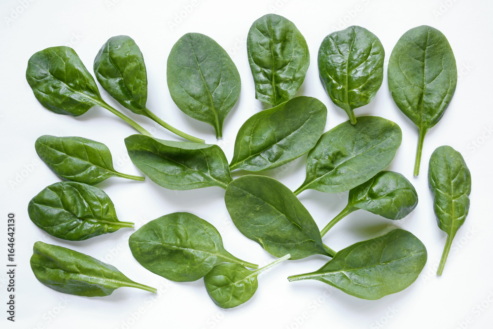 Fototapeta premium fresh baby spinach leaves on white background