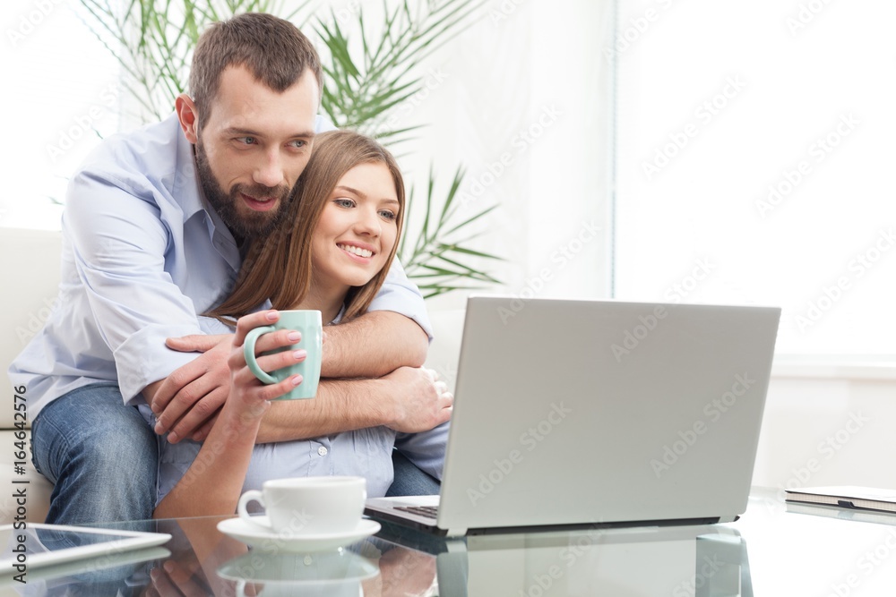 Cheerful young couple working on laptop. Cheerful young couple working on laptop.