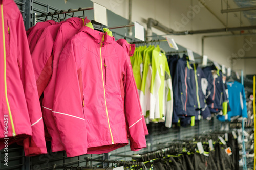 Variety of sport jackets on hangers in outdoor sports supermarket