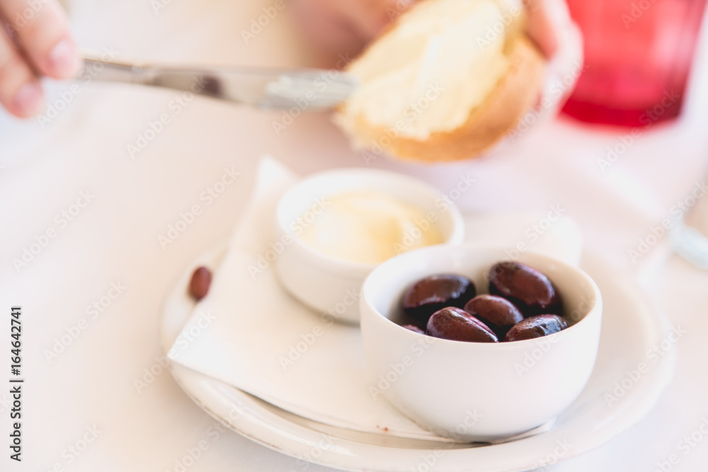 Delicious starters in Greek restaurant, bread, olives