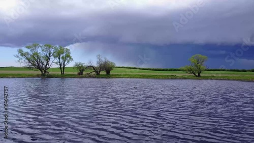 Flying over a lake with a storm in the distance