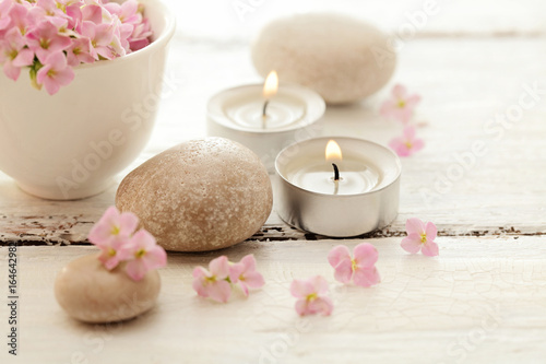 candles flowers and pebbles