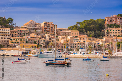 Puerto de Soller, Port of Mallorca island in balearic islands, Spain. Beautiful beach and bay with boats in clear blue water of summer day.