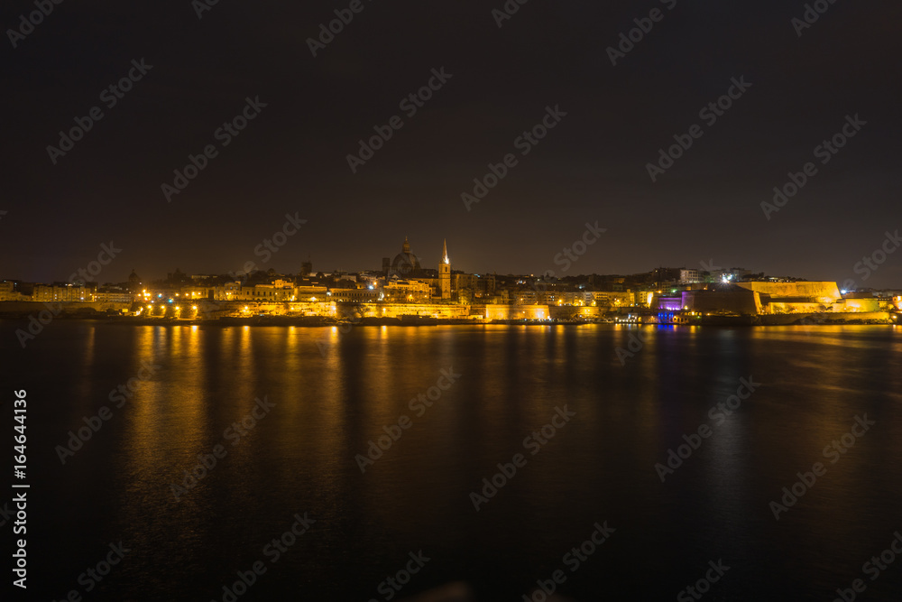 Night cityscape of Valletta seen from Sliema waterfront, Malta
