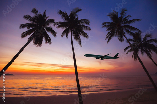 airplane taking off at sunset, holidays on tropical island concept, flight, beach travel