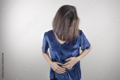 woman having painful stomachache.