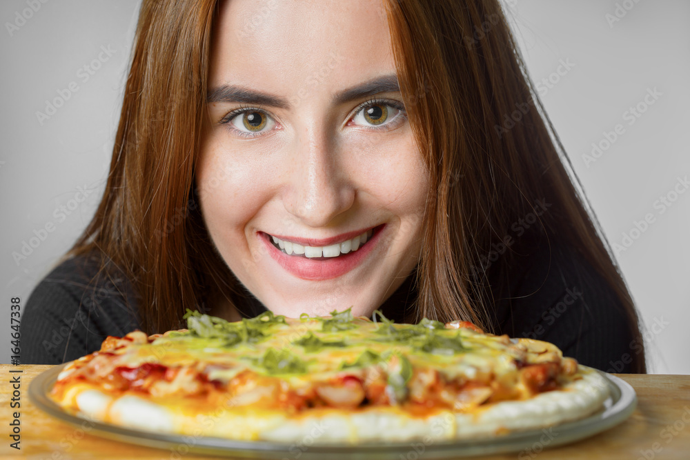 happy girl with fresh homemade pizza smiling closeup