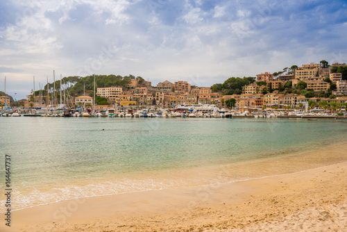 Puerto de Soller, Port of Mallorca island in balearic islands, Spain. Beautiful beach and bay with boats in clear blue water of summer day.