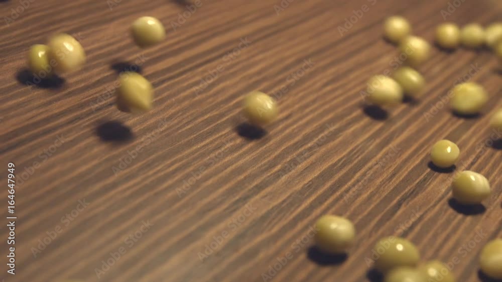 Canned green peas on a brown wooden background. 2 Shots. Slow motion. Vertical pan. Close-up. Canned green peas on a brown wooden background. 2 Shots. Slow motion. Vertical pan. Close-up.