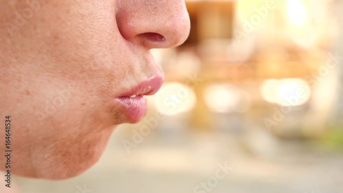 A woman chewing food from a close-up fork. profile. Slow motion