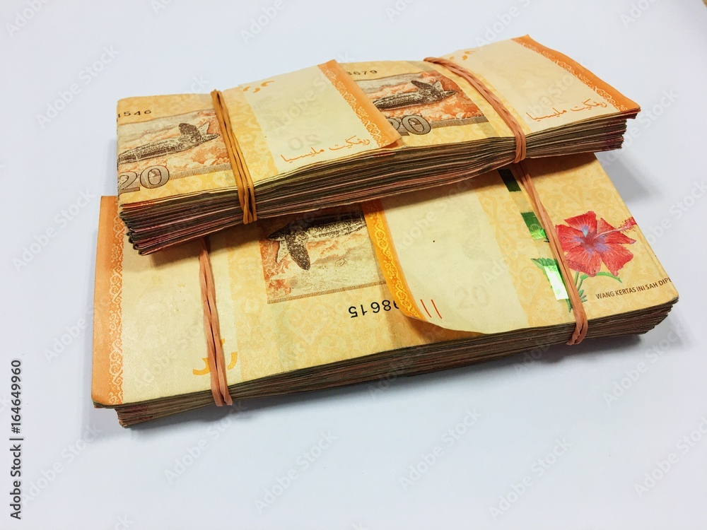 Malaysia Currency (MYR): Stack of Ringgit Malaysia bank note with isolated white background. There are ten and twenty ringgit Malaysia. Malaysia Currency (MYR): Stack of Ringgit Malaysia bank note with isolated white background. There are ten and twenty ringgit Malaysia.