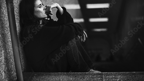 Quadro su tela Adult Woman Sitting Look Worried on The Stairway