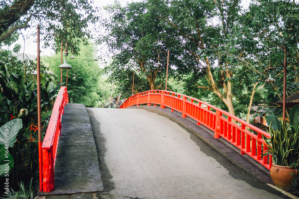 The bridge with red Rail bridge in garden. The bridge with red Rail bridge in garden.