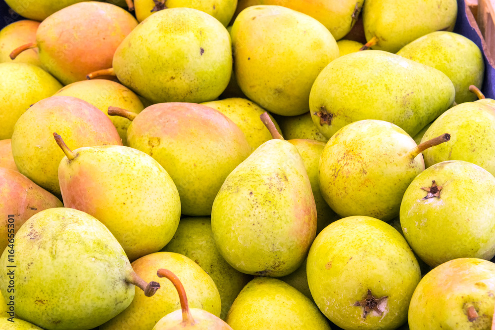 Background from yellow pears for sale at a market