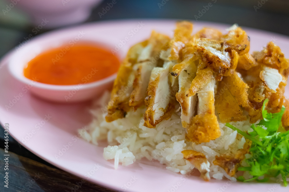 Roasted Chicken Rice with sauce and vegetable on plate on table, shallow focus. Roasted Chicken Rice with sauce and vegetable on plate on table, shallow focus.
