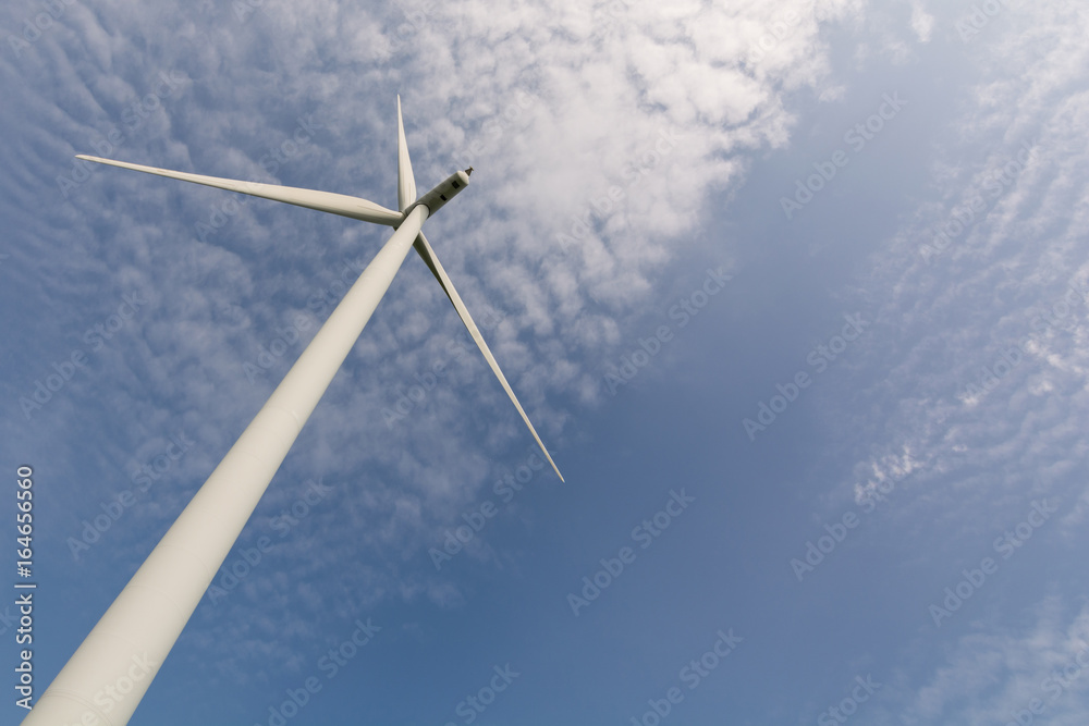 Wind turbine to generate electricity with white clouds and blue sky beautiful. renewable energy source. Wind turbine to generate electricity with white clouds and blue sky beautiful. renewable energy source.