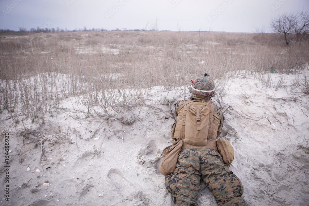 Naklejka premium Soldiers from US Navy Amphibious Squadron 8 assault an enemy strong point during a NATO military exercise