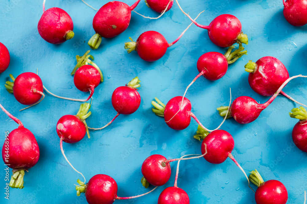vibrant fresh radish on blue wooden board, flat lay vibrant fresh radish on blue wooden board, flat lay