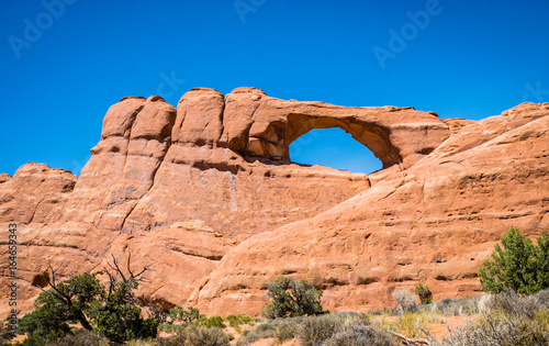 Stone sandstone cliffs and natural arches in the Arches National Park
