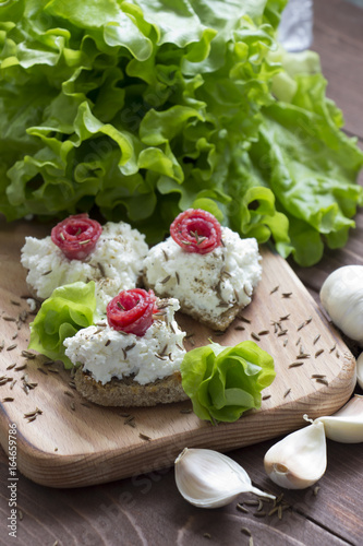 Cream cheese sandwiches with salami and salad leaves,healthy food.