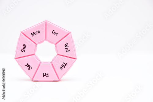 Heptagonal dispenser for a week of pills isolated against a white background photo