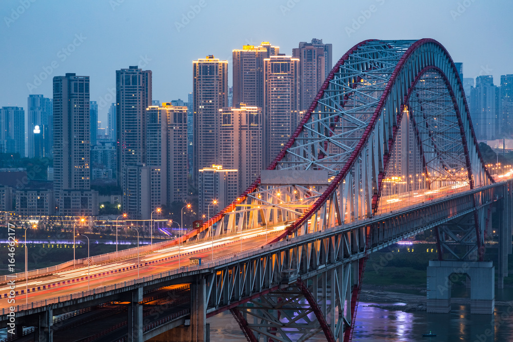 Long bridge across river at night in city of China.