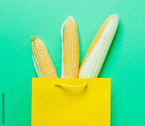 Above view at three fresh corns in shopoing bag photo