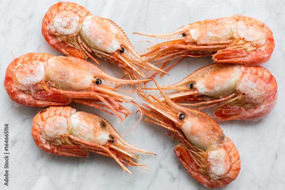 Beautiful fresh shrimps on a light marble background Beautiful fresh shrimps on a light marble background
