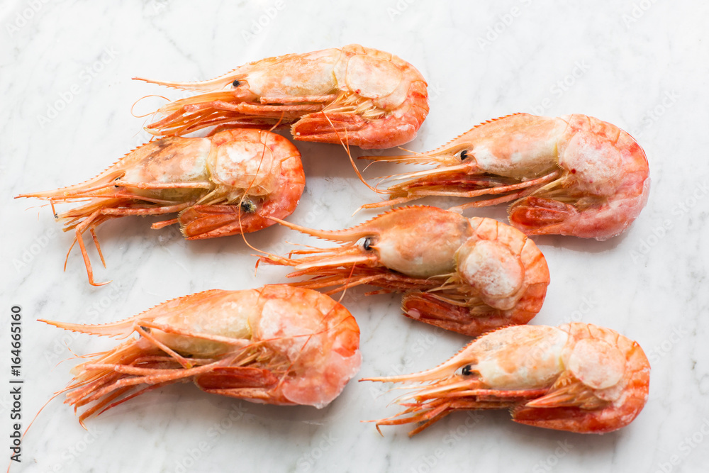 Beautiful fresh shrimps on a light marble background Beautiful fresh shrimps on a light marble background