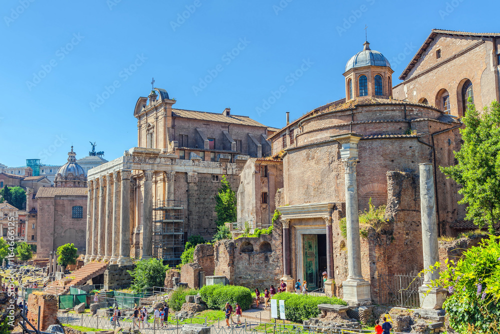 Rome, ITALY - JUNE 13, 2013: Tourists visiting the ancient ruins of the Roman Forum.