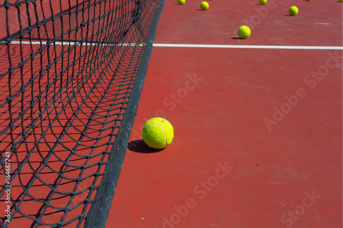 tennis ball on a tennis court with net © fotofabrika