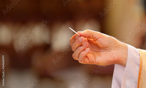 Priest gives holy communion to faithful
