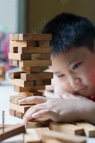 Asian boy is playing wood block.