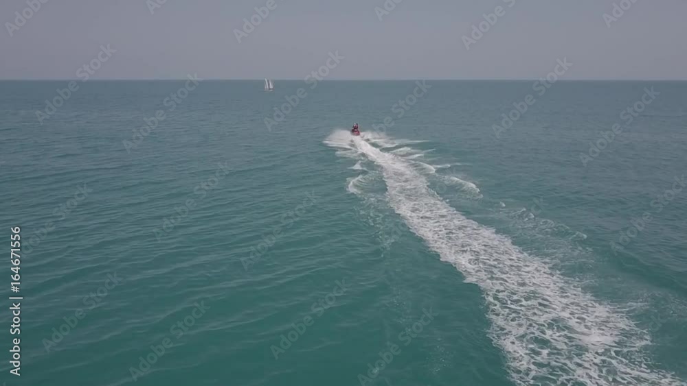 hydrocycle rides around the catamaran in the Black sea viewing from drone in slow motion hydrocycle rides around the catamaran in the Black sea viewing from drone in slow motion
