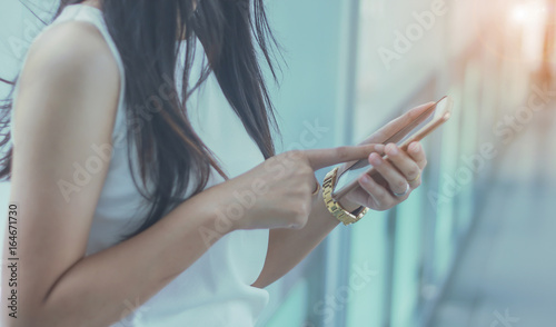 woman presses on screen digital smartphone, social media concept, selective focus,