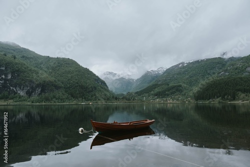 Landscape on a lake among the mountains with a boat