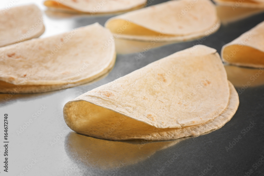 Yummy unleavened tortillas on metal kitchen table Yummy unleavened tortillas on metal kitchen table