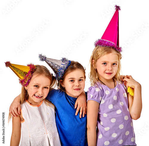 Birthday children celebrate party and eating cake on plate together. Portrait of three kids happy girl in party hat on isolated. Sisters of holiday girl at celebration.